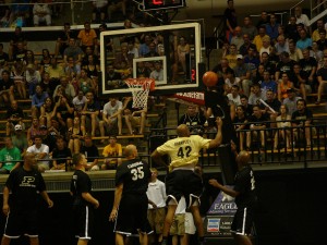 Brian Cardinal, No. 35,  looks on as Brandon Brantley goes up strong for a rebound during the Alumni Game.