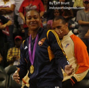Tamika Catchings poses with her Olympic gold medal.