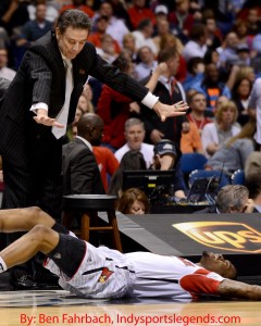 Louisville coach Rick Pitino stands over injured guard Kevin Ware. Ware broke his right leg during the Cardinals' win over Duke in the Midwest Regional Final. Photo by Ben Fahrbach.