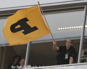 Robbie Hummel waves the Purdue flag at a football game in 2012.