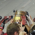Indiana players celebrate Saturday with the Old Oaken Bucket trophy. (Photo by Chris Goff.)