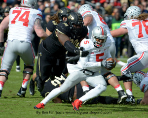 Purdue's Bruce Gaston (90) gets ahold of Ohio State quarterback Braxton Miller in 2013. Miller is now a receiver, and the quarterback play has fallen off.