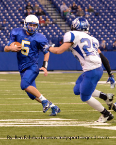 Tri-Central quarterback Cody Howell takes off as Eastern Hancock's Cooper Henderson defends. 