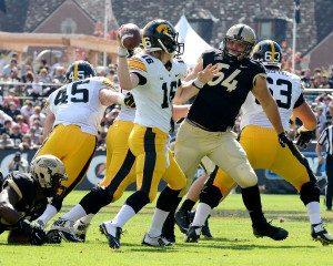 Iowa quarterback C.J. Beathard is pressured by Purdue's Jake Replogle. Photo by Ben Fahrbach.