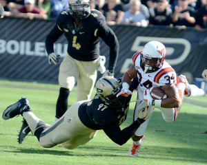 Purdue's Michael Rouse (97) takes down Virginia Tech's Travon McMillian. Photo by Ben Fahrbach.