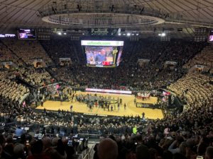 Purdue Football Head Coach Jeff Brohm speaks during a timeout. The football team brought the Foster Farms Bowl trophy onto the court to share with the fans. -photo by Keith Carrell